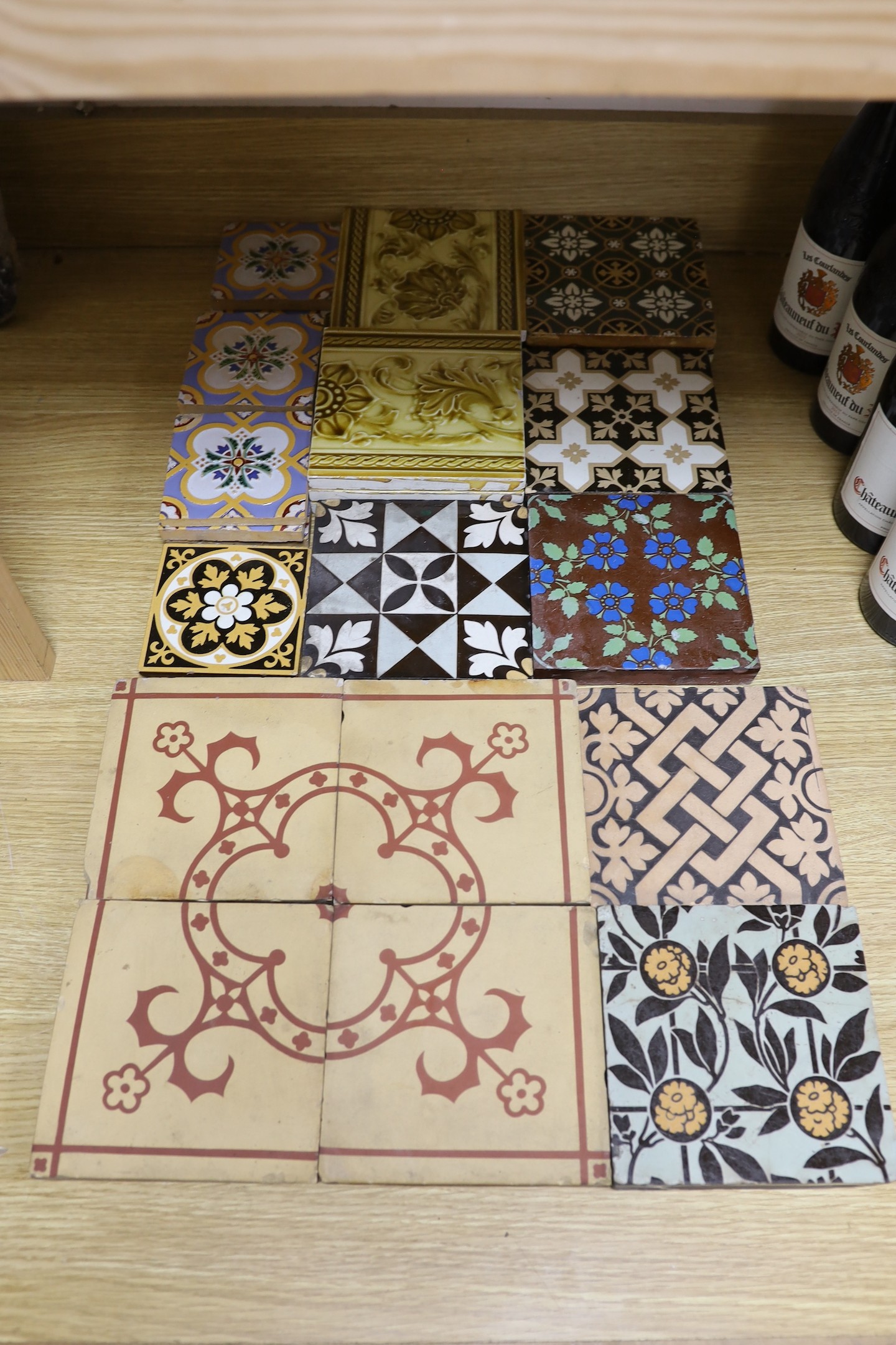 A selection of 19th and 20th century tiles, including Minton encaustic and W. Godwin tiles